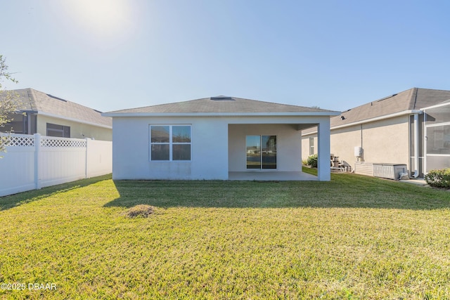 back of property with a patio and a yard