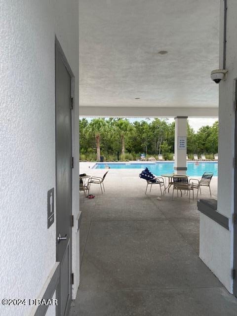 view of swimming pool featuring a patio