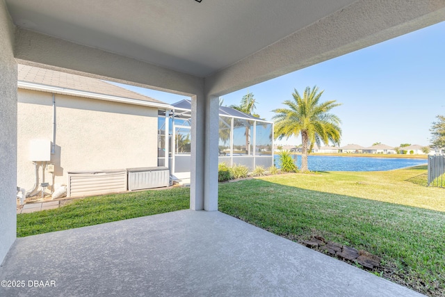 view of patio featuring a lanai and a water view