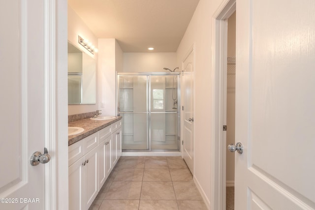 bathroom with vanity, tile patterned flooring, and a shower with shower door