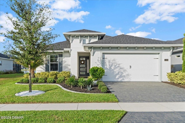 view of front of home with a front lawn and a garage