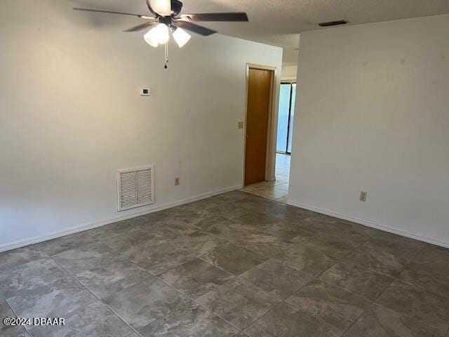 spare room featuring a textured ceiling and ceiling fan