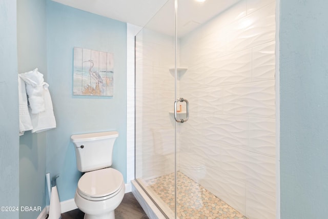 2625 S Atlantic Ave Unit 8Ne, Daytona Beach, FL 32118 - full bathroom featuring a stall shower, toilet, baseboards, and wood finished floors