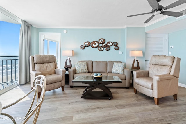 living room with light wood-type flooring, ceiling fan, and crown molding