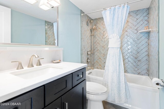 full bathroom with vanity, shower / bath combination with curtain, and toilet