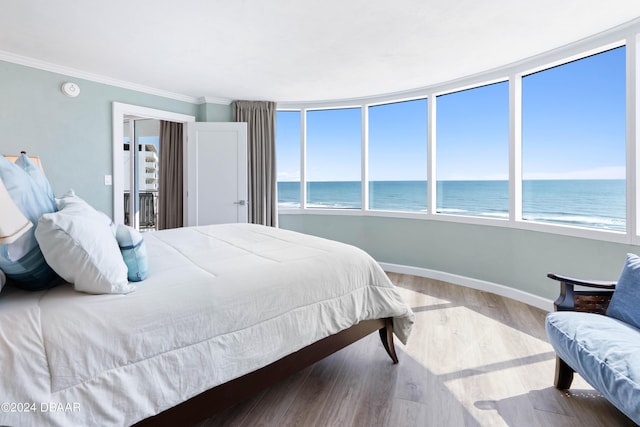 2625 S Atlantic Ave Unit 8Ne, Daytona Beach, FL 32118 - bedroom with a water view, baseboards, wood finished floors, multiple windows, and crown molding