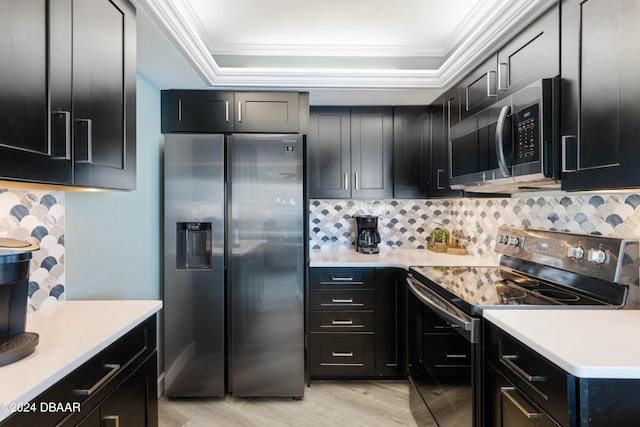 2625 S Atlantic Ave Unit 8Ne, Daytona Beach, FL 32118 - kitchen with appliances with stainless steel finishes, ornamental molding, light wood finished floors, and dark cabinetry