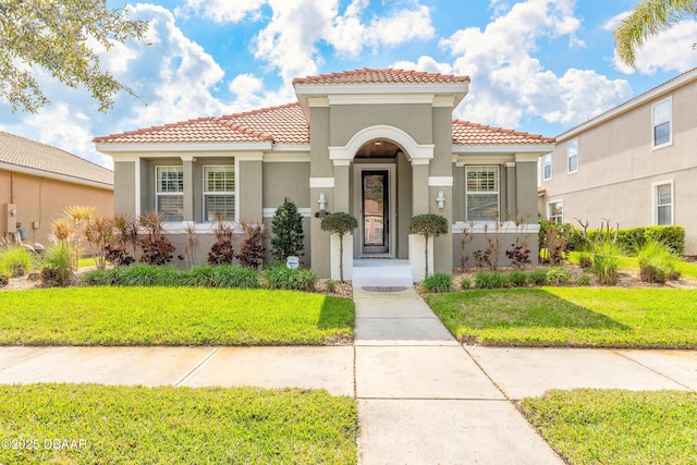 mediterranean / spanish house with a front lawn