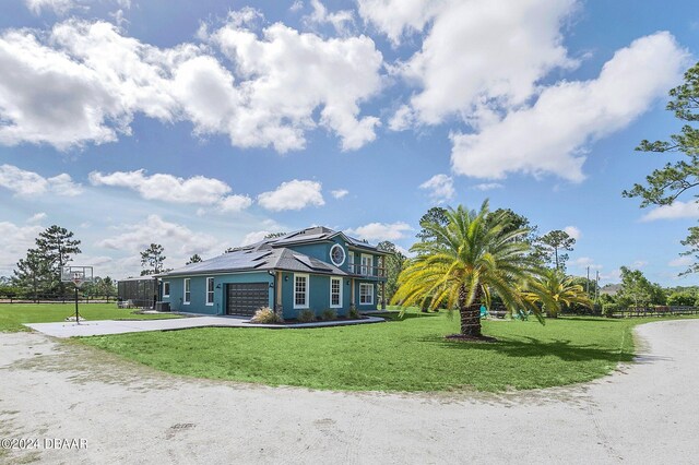 view of front of property with a garage and a front lawn