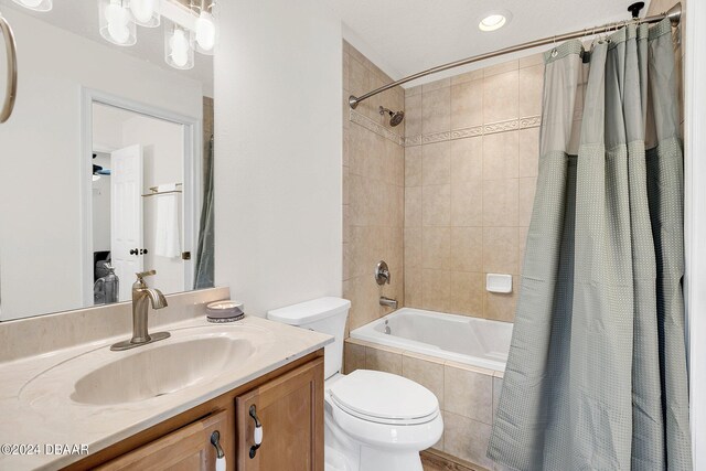 full bathroom with toilet, vanity, and shower / bath combo with shower curtain