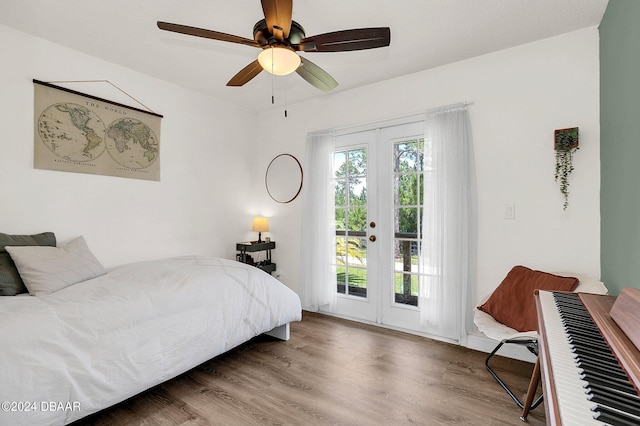 bedroom featuring access to outside, hardwood / wood-style floors, and ceiling fan