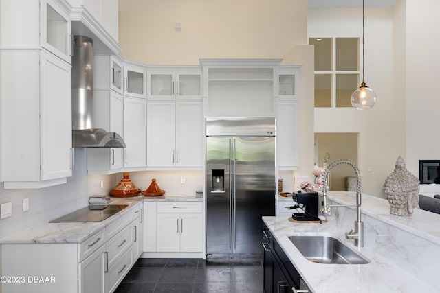 200 John Anderson Dr, Ormond Beach, FL 32176 - kitchen featuring built in refrigerator, a sink, wall chimney range hood, black electric cooktop, and tasteful backsplash