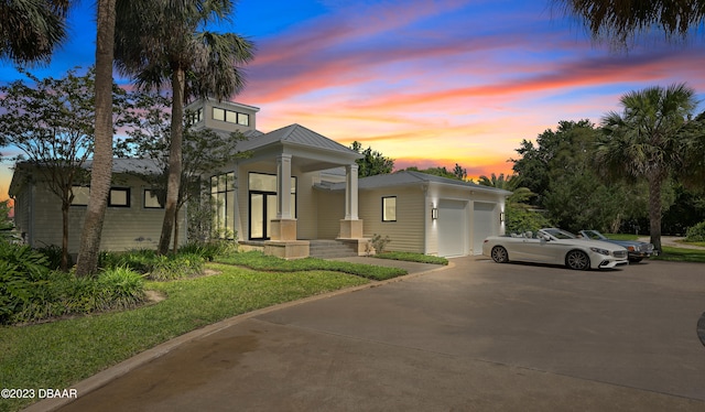 view of front facade featuring a lawn and a garage