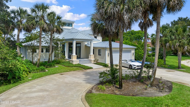 view of front facade with a garage, a front lawn, and covered porch