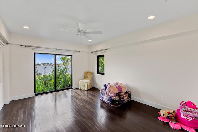 rec room with ceiling fan and dark hardwood / wood-style floors