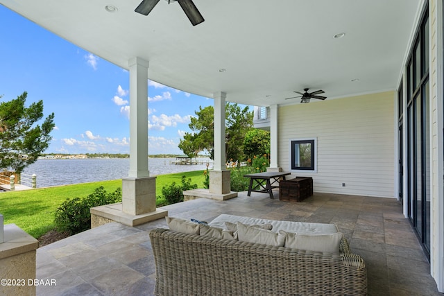 view of patio featuring a water view and ceiling fan