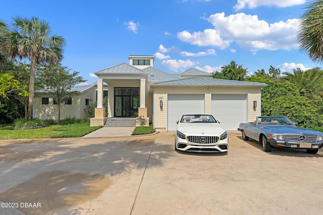 200 John Anderson Dr, Ormond Beach, FL 32176 - view of front of home featuring a standing seam roof, driveway, metal roof, and an attached garage