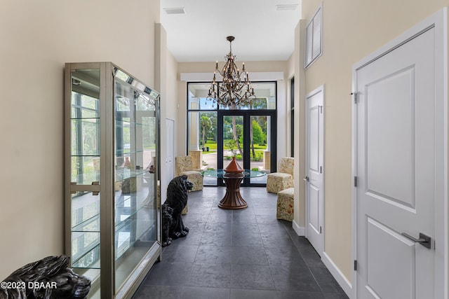 interior space featuring french doors and an inviting chandelier