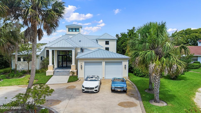200 John Anderson Dr, Ormond Beach, FL 32176 - view of front facade with a standing seam roof, a front yard, metal roof, and concrete driveway