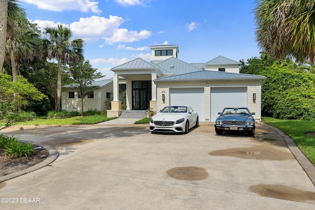 200 John Anderson Dr, Ormond Beach, FL 32176 - view of front of house with driveway, a standing seam roof, and an attached garage