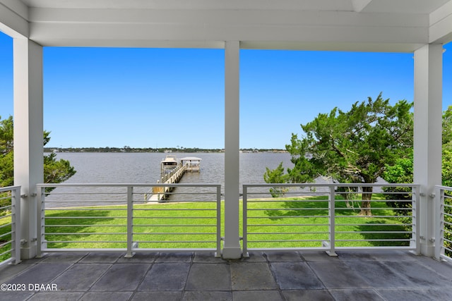 view of patio with a balcony and a water view