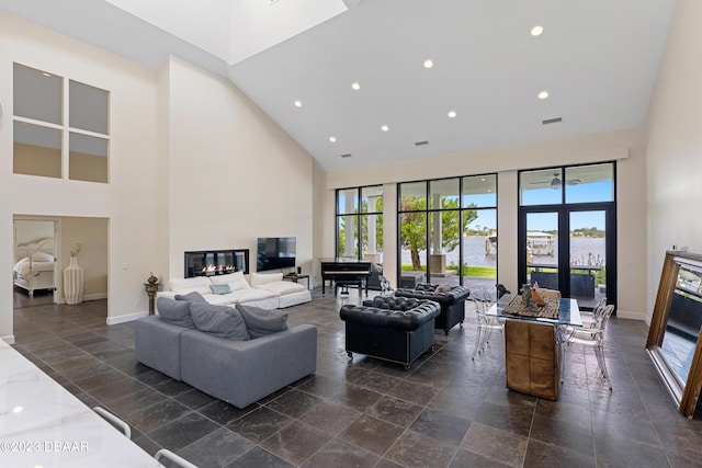 200 John Anderson Dr, Ormond Beach, FL 32176 - living area with high vaulted ceiling, healthy amount of natural light, recessed lighting, a glass covered fireplace, and baseboards