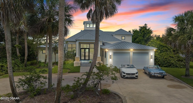 200 John Anderson Dr, Ormond Beach, FL 32176 - view of front of home with driveway, a garage, a standing seam roof, and metal roof