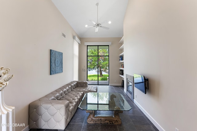 living room with high vaulted ceiling and ceiling fan