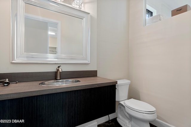 bathroom featuring toilet and vanity