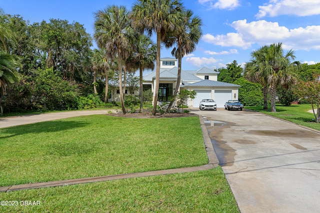 view of front of property with a garage and a front lawn