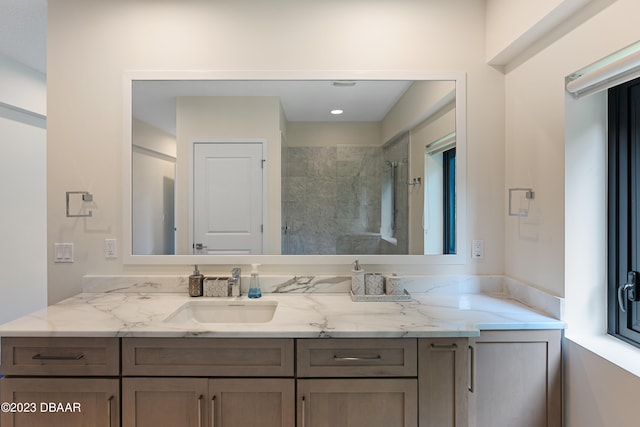 bathroom with vanity and tiled shower