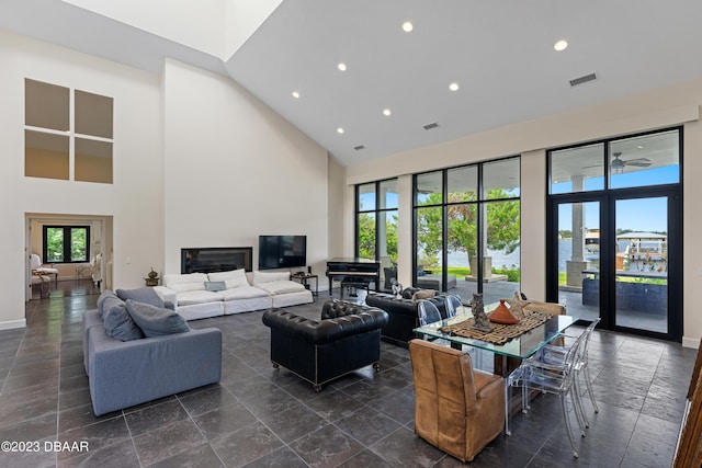 200 John Anderson Dr, Ormond Beach, FL 32176 - living area featuring a high ceiling, recessed lighting, baseboards, and stone tile floors