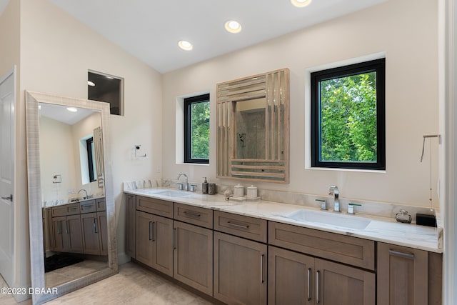 bathroom with lofted ceiling and vanity