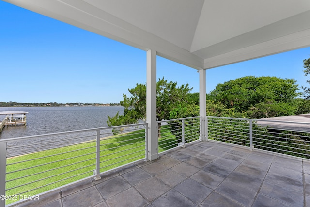 view of patio with a water view and a balcony