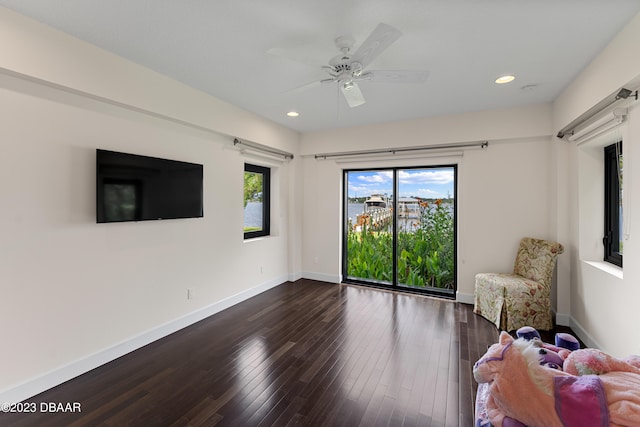 interior space with ceiling fan and dark hardwood / wood-style floors