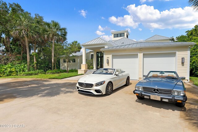 200 John Anderson Dr, Ormond Beach, FL 32176 - view of front of home featuring concrete driveway, a standing seam roof, and a garage