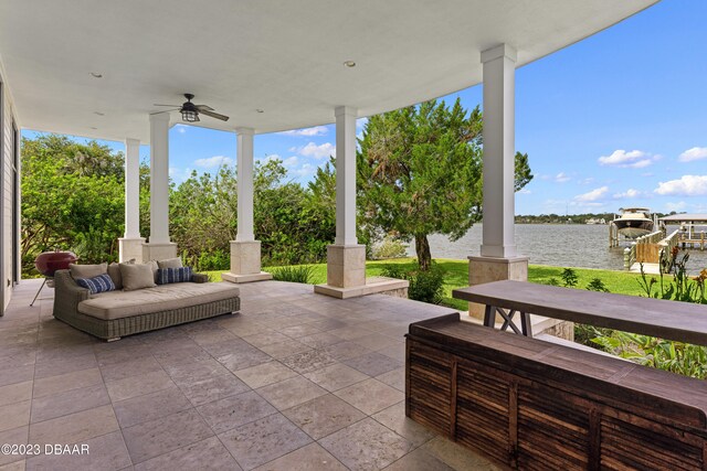 view of patio / terrace featuring a water view and ceiling fan