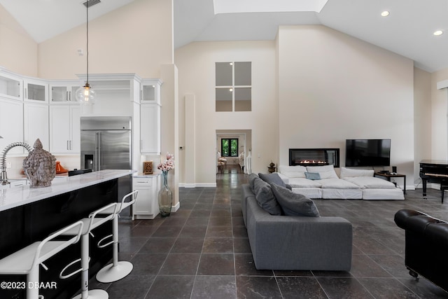 200 John Anderson Dr, Ormond Beach, FL 32176 - living room featuring high vaulted ceiling, recessed lighting, baseboards, and a glass covered fireplace