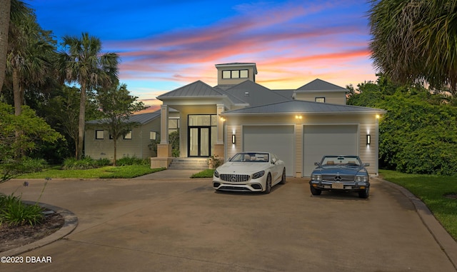 200 John Anderson Dr, Ormond Beach, FL 32176 - view of front facade with asphalt driveway, a garage, a standing seam roof, and metal roof