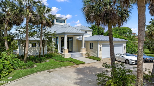 view of front of property featuring a garage, a front yard, and a porch