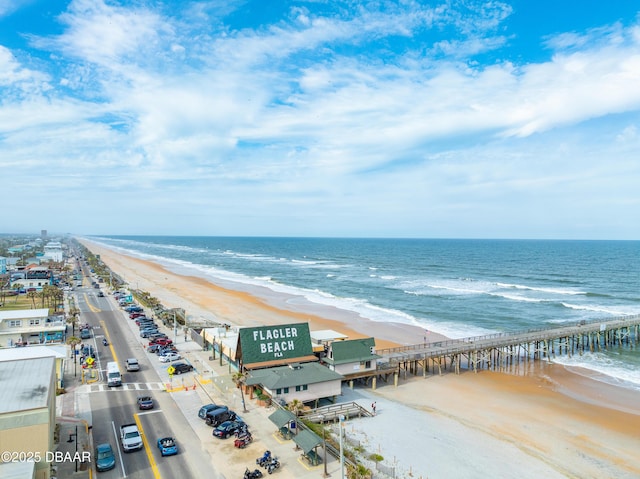 drone / aerial view featuring a beach view and a water view