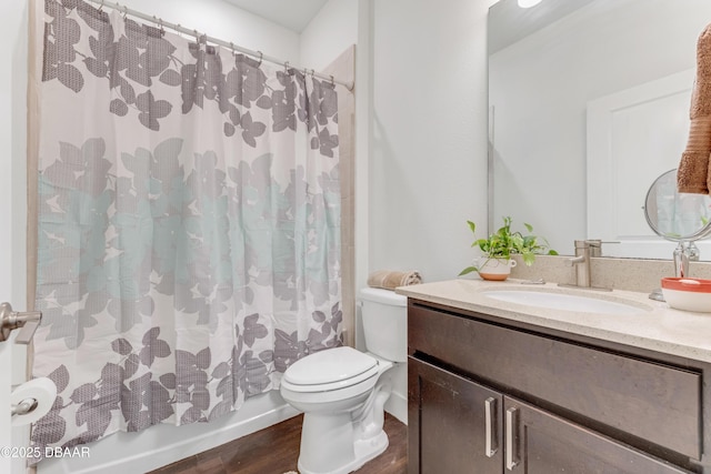 bathroom with shower / bath combo with shower curtain, toilet, wood finished floors, and vanity