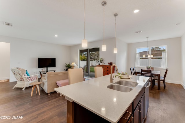 kitchen featuring a wealth of natural light, visible vents, dark wood-type flooring, a sink, and dishwasher