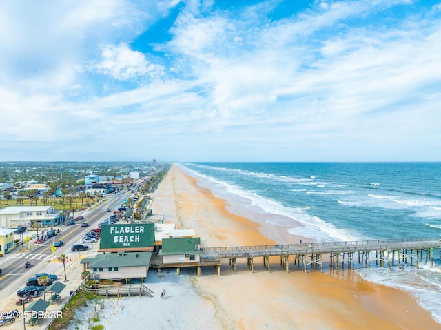 drone / aerial view featuring a water view and a beach view