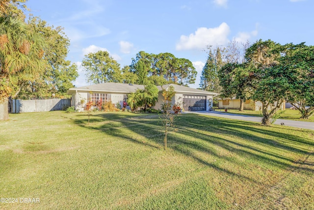 ranch-style house featuring a front yard and a garage