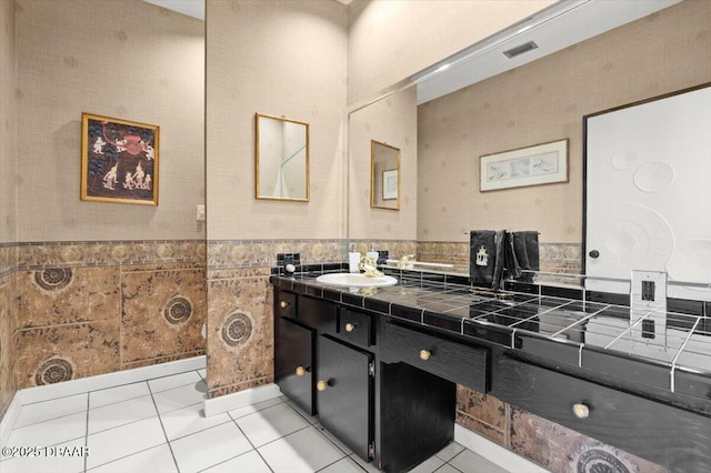 915 Ocean Shore Blvd Unit 801, Ormond Beach, FL 32176 - bathroom featuring tile patterned flooring, vanity, wainscoting, and tile walls