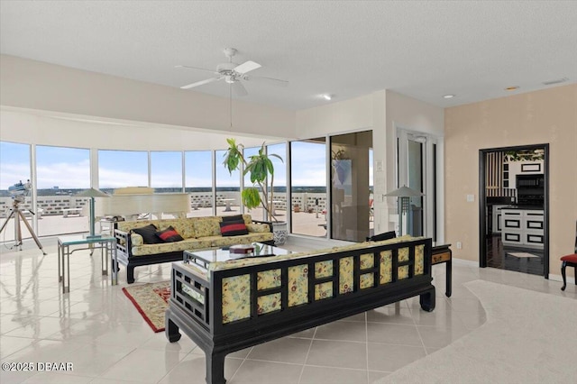 915 Ocean Shore Blvd Unit 801, Ormond Beach, FL 32176 - living room with healthy amount of natural light, a ceiling fan, a textured ceiling, and tile patterned flooring