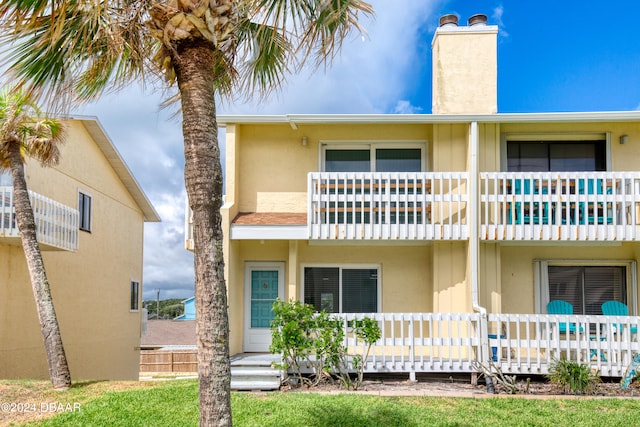 back of property featuring a balcony