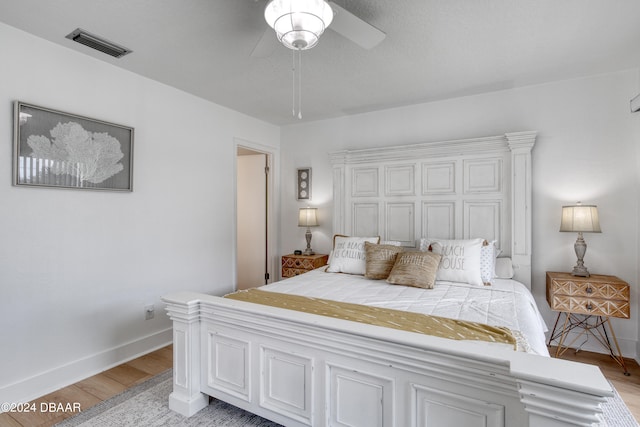 bedroom with light hardwood / wood-style floors and ceiling fan