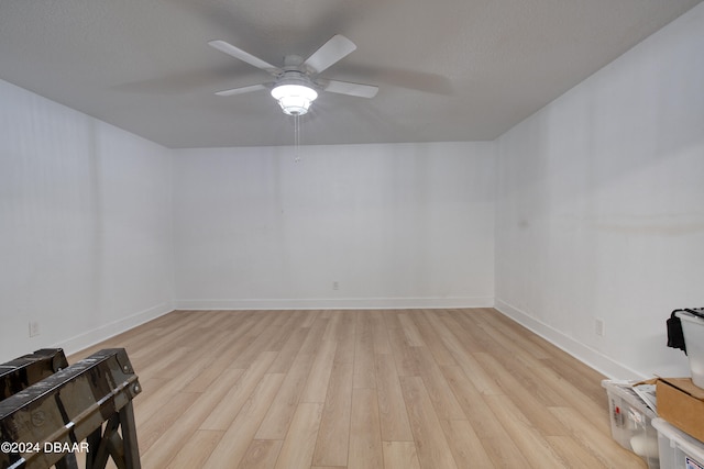 spare room with light wood-type flooring and ceiling fan